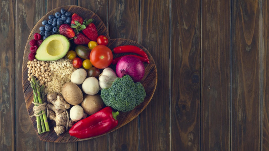 Healthy food on a heart shape cutting board.